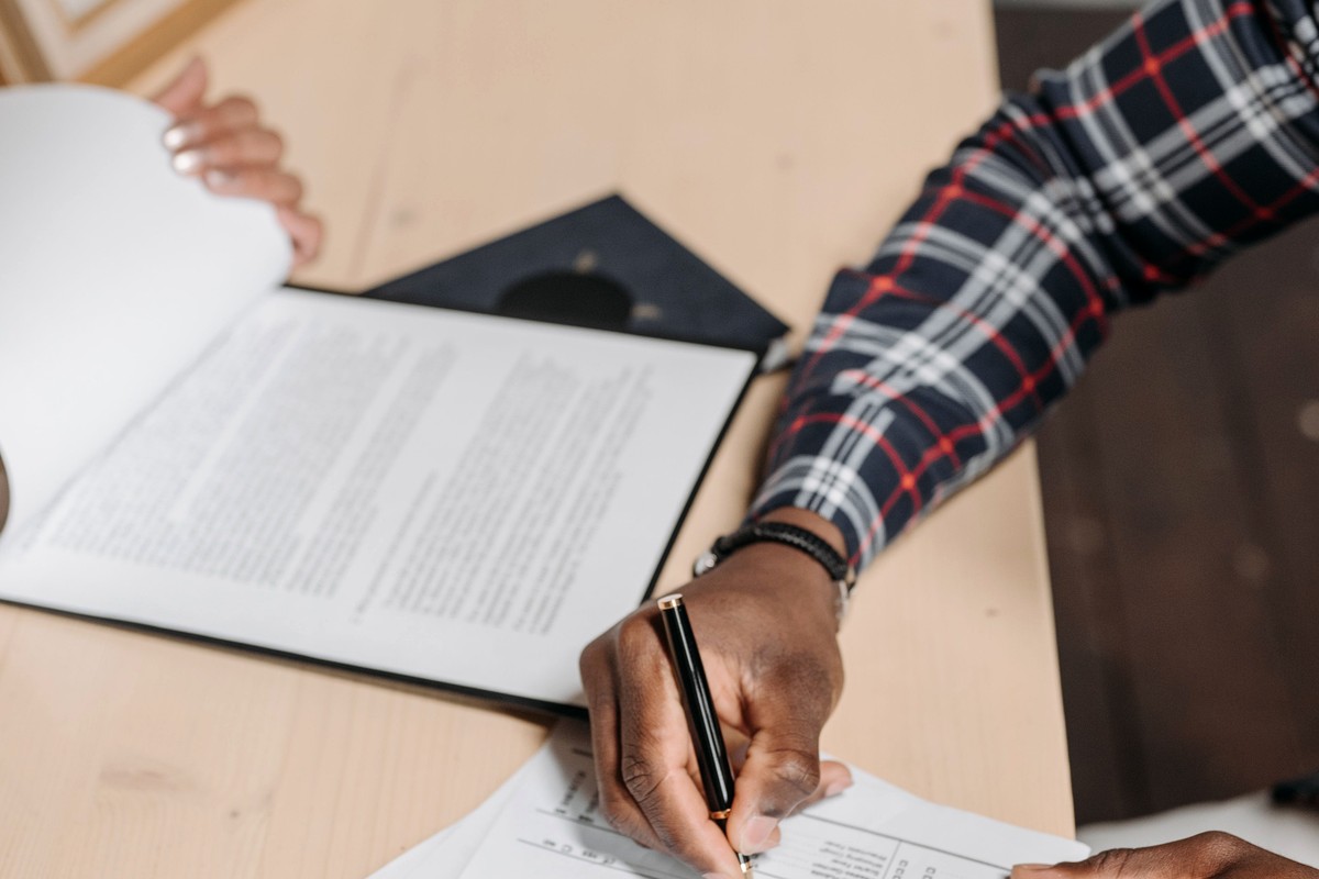 Customer completing legal paperwork with professional assistance